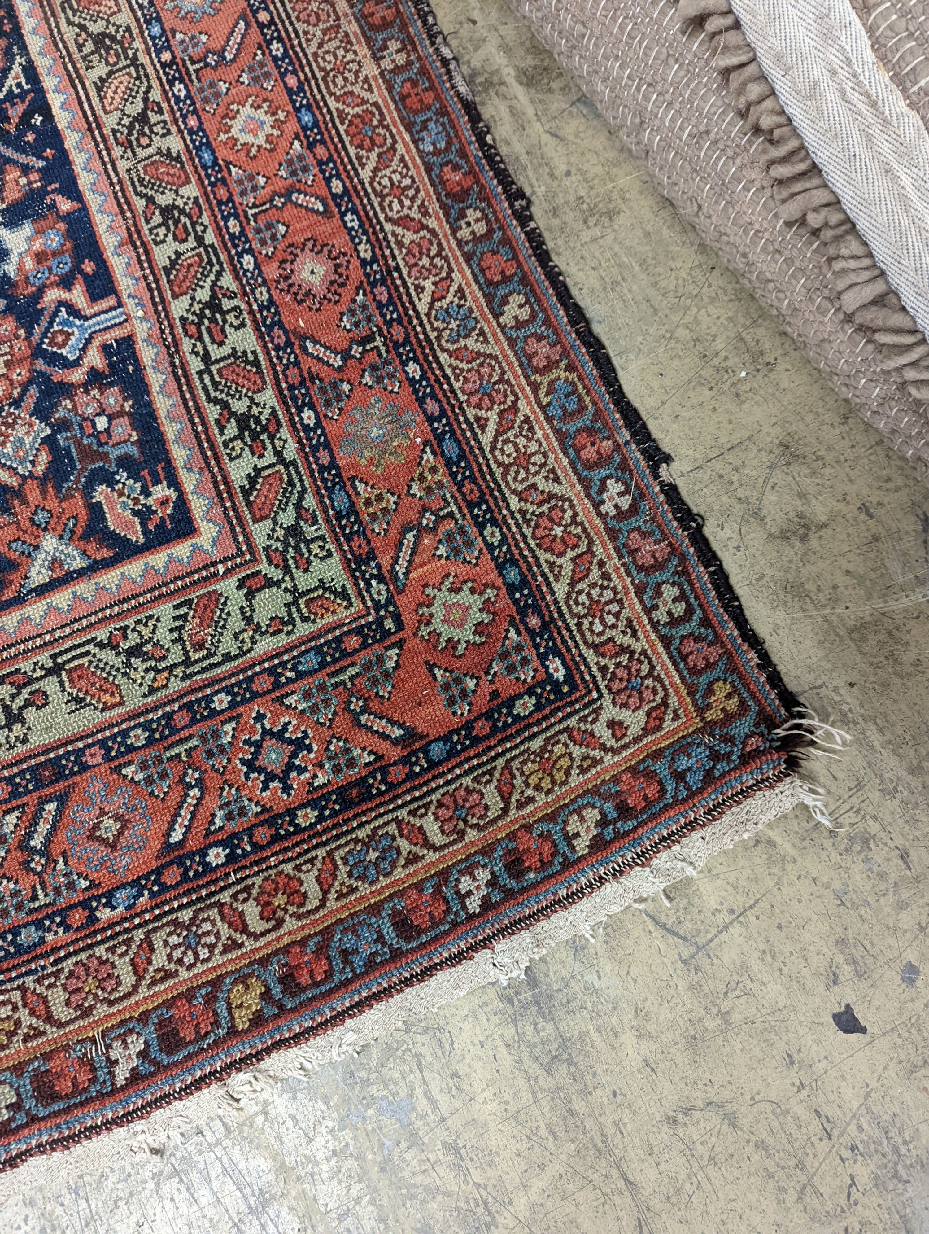 A Ferraghan blue and red brick carpet, 345 x 161cm